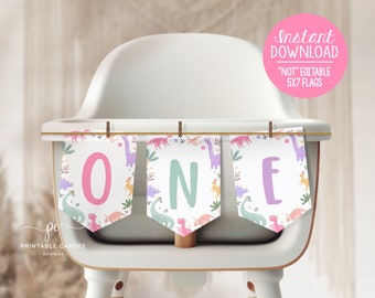 May include: A printable dinosaur-themed banner for a first birthday party. The banner is made of five flags with the word "ONE" printed on them. The flags are pink, green, and purple and feature a dinosaur pattern.