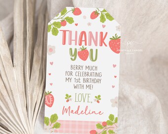 May include: A pink and green thank you tag with a strawberry design. The tag says "Thank You" with a strawberry in the "O". It also says "Berry Much for Celebrating My 1st Birthday with Me! Love, Madeline".