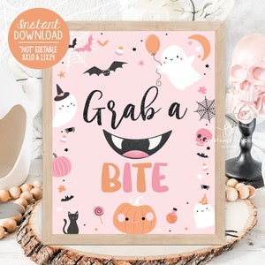 May include: Pink printable sign with the text "Grab a Bite" in black and white. The sign is decorated with Halloween themed illustrations including ghosts, bats, pumpkins, and candy.