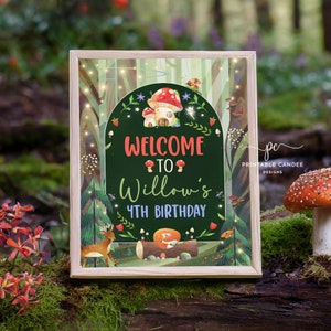 May include: A printable sign with a woodland theme. The sign says "Welcome to Willow's 4th Birthday" with a mushroom house and a deer in the background.