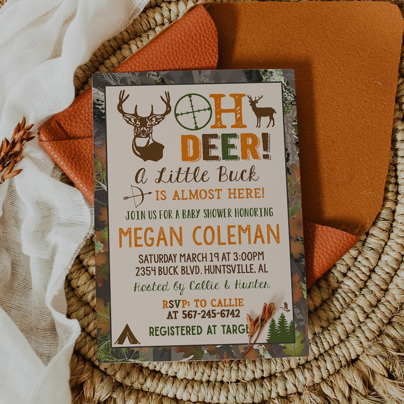 May include: A baby shower invitation with a camouflage background. The text reads "Oh Deer! A Little Buck is Almost Here!" with a deer silhouette and a target symbol. The invitation includes the name Megan Coleman, the date and time of the shower, the address, and the names of the hosts. It also includes the RSVP information and the registry location.