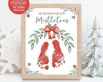 May include: A printable Christmas-themed baby footprint art print with a red bow and green leaves. The text reads "Love you from my head to my Mistletoes".