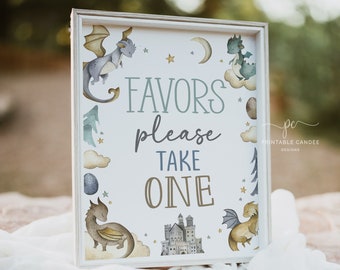 May include: A white sign with a light wood frame and the text "Favors please take one" in blue and brown lettering. The sign is decorated with illustrations of dragons, stars, clouds, and a castle.
