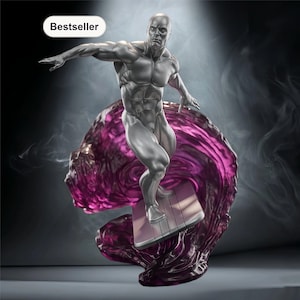 May include: A silver statue of a muscular figure surfing on a purple wave. The figure is on a silver surfboard. The statue is labeled "Bestseller" in a white oval.