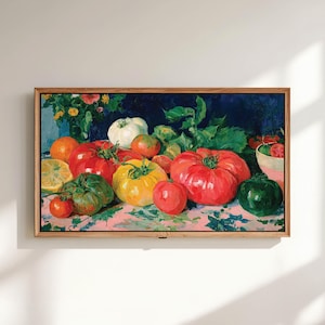 May include: A framed oil painting depicting a vibrant still life of assorted heirloom tomatoes in shades of red, yellow, green, and white, arranged on a pink surface with green leaves, a sliced lemon, and a small bowl against a dark blue background.