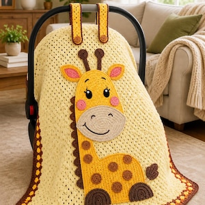 May include: A yellow crocheted baby car seat cover with a giraffe applique. The giraffe has brown spots, a tan face, and pink accents. The cover has brown and yellow trim and straps.