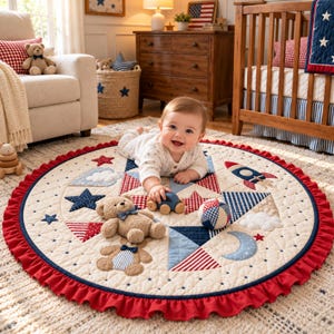 May include: A round, quilted play mat featuring a patriotic theme with red, white, and blue colors. The mat displays star, rocket, cloud, and moon patterns, accented by a ruffled red border and two plush teddy bears with blue bow ties.