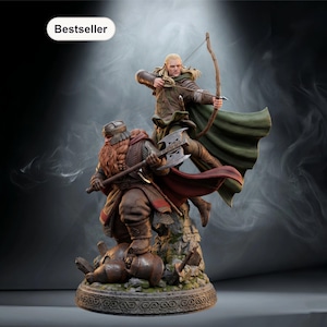 May include: A detailed figurine of two characters in a battle scene. One figure is an archer with a bow and arrow, and the other is a warrior with an axe. The figures are on a rocky base with a decorative border. The word "Bestseller" is in the top left corner.