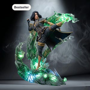 May include: A detailed figurine of a woman in a dynamic martial arts pose. She wears a black and gold outfit, with a flowing cape. The figure is set on a glowing green crystal base with intricate details. The word "Bestseller" is in a white oval.