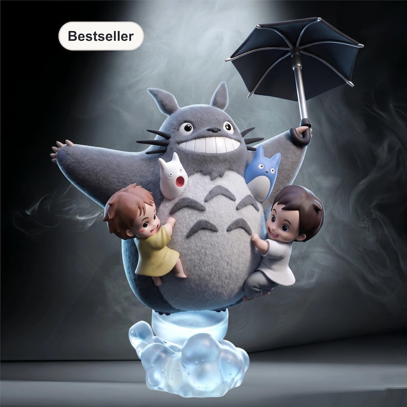 May include: A gray Totoro figure with an open umbrella, holding two small children and two smaller Totoro-like creatures. The figure is on a cloud-shaped base that emits a blue glow. The word "Bestseller" is in the top left corner.
