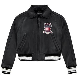 May include: Black leather bomber jacket with a zip-up front, collar, and ribbed cuffs and hem. The jacket features a patch on the chest with the text "AVIREX" and an American flag design. The cuffs and hem have white stripes.