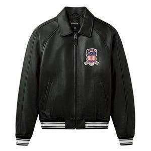 May include: Black leather jacket with a collared neckline, a zip-up front, and a patch on the chest featuring an American flag design. The jacket has white and black striped cuffs and hem. The brand name "AVIREX" is visible on the jacket.
