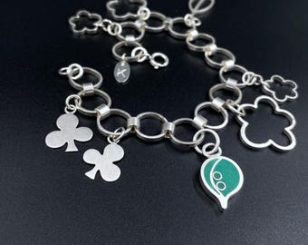 BOTANICAL charm bracelet .  sterling silver flower, clover and leaf chain . floral silhouettes