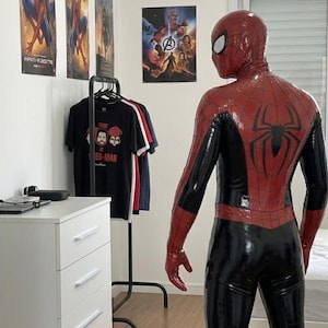 Puede incluir: Un disfraz de Spider-Man de cuerpo completo hecho de un material brillante rojo y negro. El traje presenta un prominente emblema de ara&ntilde;a negra en la espalda, un patr&oacute;n de telara&ntilde;a texturizado en las secciones rojas y una m&aacute;scara a juego.