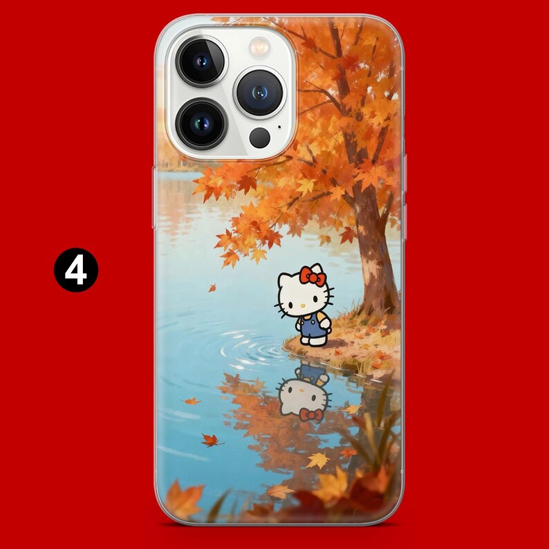 May include: Clear phone case featuring a cartoon image of Hello Kitty standing near a lake with autumn foliage. The design includes a tree with orange leaves, a reflection of Hello Kitty in the water, and falling leaves. The number 4 is in the upper left corner.