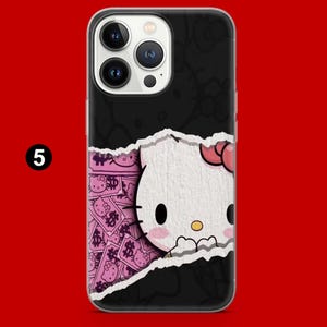 May include: Black phone case featuring a Hello Kitty design with a pink bow and a torn paper effect. The design reveals a pink background with dollar signs and more Hello Kitty images. The number 5 is in the upper left corner.