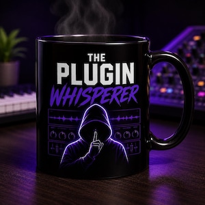 May include: Black ceramic mug with the text "THE PLUGIN WHISPERER" in white and purple. The mug features a graphic of a person in a hoodie with a finger to their lips, and a soundboard design. Steam rises from the mug.