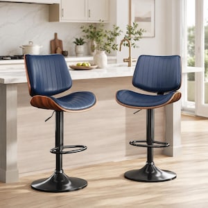 May include: Two navy blue bar stools with a curved wooden back and seat. The seats have vertical stitching. The stools have a black adjustable height base and a footrest. The stools are in a kitchen setting.