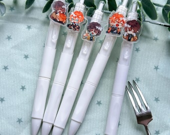 May include: Five white retractable gel pens, each featuring a unique clear acrylic charm attached to the clip. The charms display colorful anime-style character illustrations with various expressions and poses, including orange and brown hair designs.