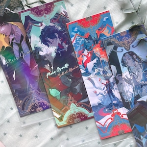 May include: Four rectangular bookmarks featuring anime-style character illustrations with intricate ornamental borders. The designs incorporate vibrant colors including red, blue, purple, and teal, with text overlays reading Klein Moretti and Bethel Abraham.