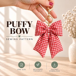 May include: A red and white gingham fabric bow keychain with a gold-toned metal lobster clasp and ring. The text PUFFY BOW SEWING PATTERN is displayed alongside icons for one size, beginner friendly, and instant download features.