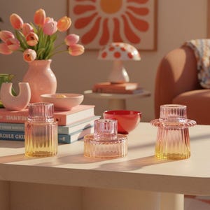 Colourful retro-inspired candle holders styled on a warm dopamine decor coffee table with playful ceramics and modern home decor accents.
