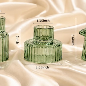 three reversible candle holders in forrest green against a cream silk background with clear dimensions visible.