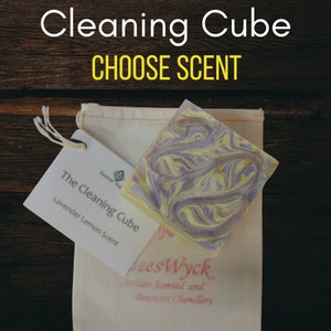 May include: A lavender lemon scented cleaning cube in a white muslin bag. The label reads "The Cleaning Cube Lavender Lemon Scent" and "bees Wyck Artisan Scented and Beeswax Chandlery".