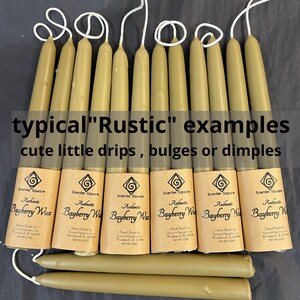 May include: Ten rustic, hand-dipped bayberry wax candles with a natural, uneven texture. The candles are labeled "Authentic Bayberry Wax" and are made by Scenter Square in Woodstock, IL.