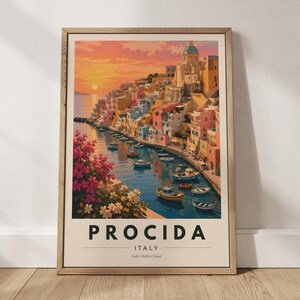 May include: A framed travel poster depicting the coastal town of Procida, Italy, at sunset. The scene features colorful buildings, a harbor with small boats, and pink flowers in the foreground. The text reads PROCIDA ITALY Italy's Hidden Island.