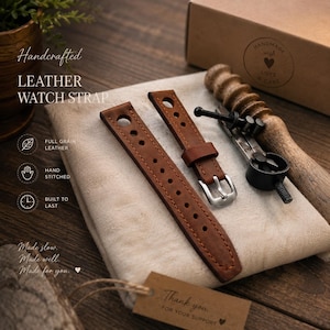 May include: Two brown leather watch straps with silver buckles and stitching, presented on a beige cloth. The image includes text that reads "Handcrafted LEATHER WATCH STRAP" and "FULL GRAIN LEATHER, HAND STITCHED, BUILT TO LAST". A tag says "Thank you for your support."