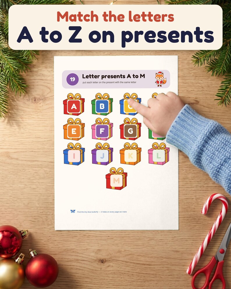A child's hand matches letter C onto a present on the Letter presents A to M page
