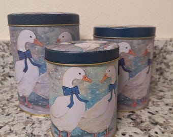 Vintage set of 3 nesting tin canisters, unused.