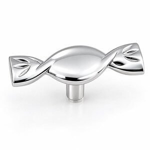 May include: A polished silver-toned metal cabinet knob shaped like a wrapped candy. The central body is smooth and rounded, while the two flared ends feature a subtle engraved leaf-like pattern. A single cylindrical post extends from the center.