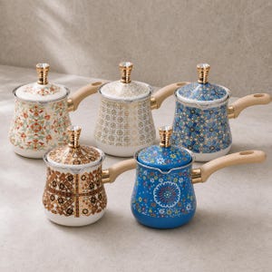 May include: Five small metal pots with lids and light-coloured wooden handles. Each pot features a unique pattern: one with red and green floral motifs, one with gold geometric lines, one with blue star patterns, one with brown lattice, and one blue floral.