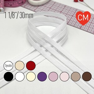 May include: A white elastic band measuring 1 1/8 inches or 30mm wide, shown with a color chart featuring circles in dyeable, beige, red, black, white, cream, purple, light pink, pale pink, tan, and brown shades for reference.