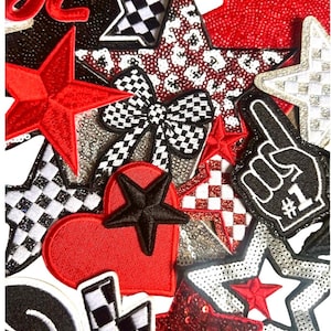 May include: A collection of embroidered patches in various shapes and patterns. The patches include stars, hearts, and a bow, with colors like red, black, white, and silver. Some patches have sequin details and checkered patterns.