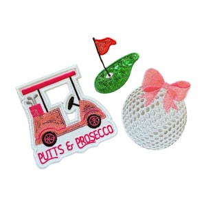 May include: Embroidered patches featuring golf-themed designs. Includes a golf cart with the text "Putts & Prosecco", a green putting green with a red flag, and a white golf ball with a pink bow.