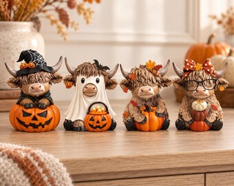 May include: Four small highland cow figurines decorated for autumn. The first wears a witch hat and sits in a jack-o'-lantern. The second wears a ghost sheet and holds a pumpkin bucket. The third has autumn leaves. The fourth wears a bow and glasses.