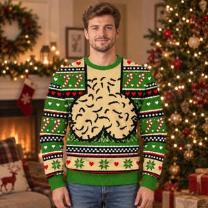 May include: A long-sleeve crew neck sweater featuring a green and beige color scheme with a central graphic of two beige, rounded, textured shapes. The design includes horizontal bands of red hearts, white candy canes, and green snowflakes.