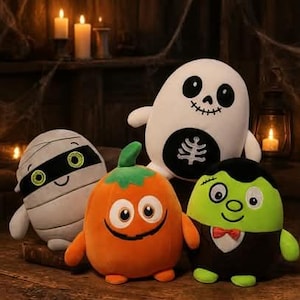 May include: A collection of four plush toys featuring a white ghost with a skeleton print, a grey mummy with green eyes, an orange pumpkin with a green stem, and a green monster wearing a black suit with a red bowtie, all with round shapes.