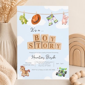 May include: A baby shower invitation card on a light blue background with white clouds. It features wooden blocks spelling BOY STORY, watercolor illustrations of a dinosaur, hat, space suit, pig, and race car, with text for Hunter Birch.
