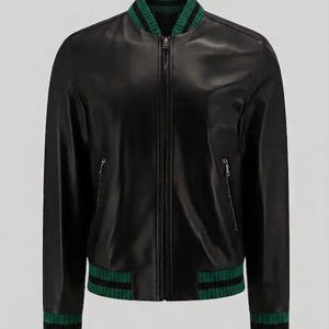 May include: A black bomber jacket featuring a smooth finish, a central front zipper, and two zippered side pockets. The collar, cuffs, and hem are made of a ribbed knit fabric in a dark green color with thin black horizontal stripes throughout.