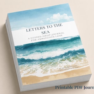 May include: A stack of journals with a watercolor illustration of a beach scene. The cover reads "Letters to the Sea: A Guided Grief Journal for Ambiguous Loss." The bottom of the journal says "Printable PDF Journal."