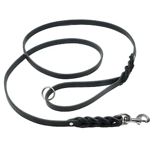 May include: A black leather dog leash featuring a braided section near the silver-toned metal swivel snap hook and a matching braided detail at the handle loop, which includes a circular metal ring for attachment and secure silver rivets.
