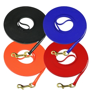 May include: Four coiled dog leashes in black, blue, orange, and red. Each leash features a smooth, flat strap material, a handle loop, and a gold-toned metal swivel snap hook attached with white stitching at the end of the strap.