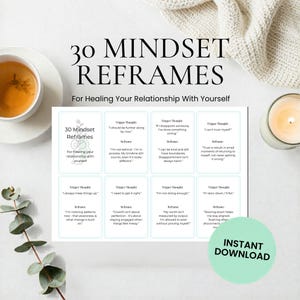 May include: A digital download titled "30 Mindset Reframes" for healing relationships. The image features a set of cards with trigger thoughts and reframes, a cup of tea, a candle, and a sprig of greenery. The words "Instant Download" are also visible.