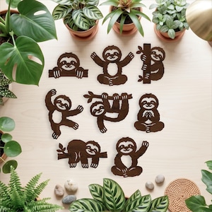 May include: A collection of eight dark brown wooden sloth cutouts in various poses, including hanging from branches, sitting, and waving. Each sloth features a simple, flat design with cut-out details for the face and body, arranged on a light surface.