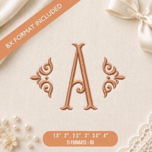 May include: An embroidered copper-coloured letter A monogram flanked by two decorative scrollwork flourishes on a light fabric background. Text on the image includes BX FORMAT INCLUDED and 1.5", 2", 2.5", 3", 3.5", 4" 11 FORMATS + BX.