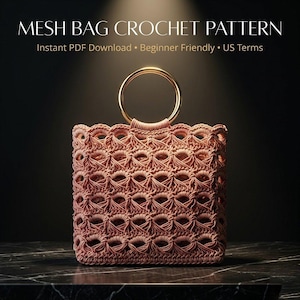 May include: A crocheted mesh bag in a dusty rose color, featuring a gold-colored circular handle. The bag has a textured, open weave design. Text at the top reads "MESH BAG CROCHET PATTERN". Additional text states "Instant PDF Download • Beginner Friendly • US Terms".